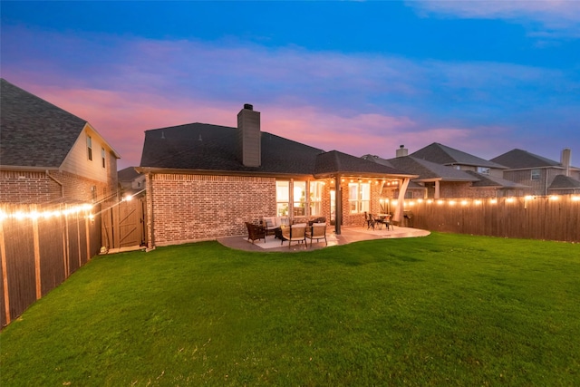 11701 Parade Dr, Frisco, TX 75036 - back of property at dusk featuring brick siding, a chimney, a patio area, and outdoor lounge area