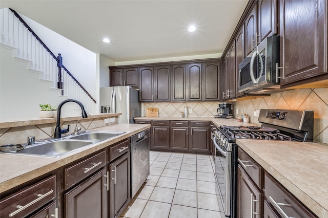 7812 Rancho De La Osa Trl, Mckinney, TX 75070 - kitchen featuring stainless steel appliances, a sink, dark brown cabinets, decorative backsplash, and recessed lighting