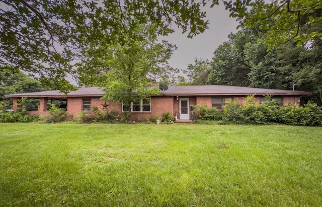 700 Magnolia St, Teague, TX 75860 - ranch-style home featuring brick siding and a front lawn