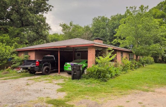 700 Magnolia St, Teague, TX 75860 - view of side of property featuring brick siding, a carport, a chimney, and dirt driveway