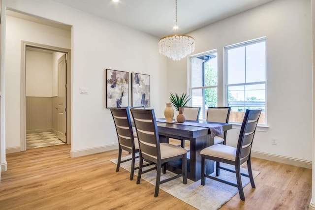 407 Baldwin Dr, Joshua, TX 76058 - dining space featuring light wood-type flooring, a chandelier, and baseboards