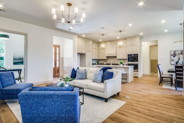 407 Baldwin Dr, Joshua, TX 76058 - living area featuring a chandelier, baseboards, light wood-style flooring, and recessed lighting