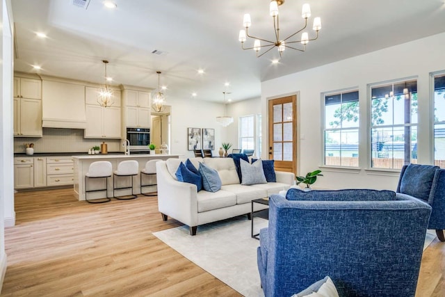 407 Baldwin Dr, Joshua, TX 76058 - living area with a chandelier, light wood-type flooring, and recessed lighting