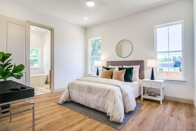 407 Baldwin Dr, Joshua, TX 76058 - bedroom with light wood-style flooring, connected bathroom, baseboards, and recessed lighting