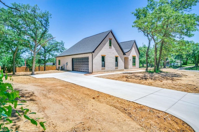 407 Baldwin Dr, Joshua, TX 76058 - view of front of house with concrete driveway, brick siding, and a garage