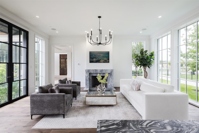 5531 Walnut Hill Ln, Dallas, TX 75229 - living area featuring a chandelier, crown molding, wood finished floors, a high end fireplace, and recessed lighting