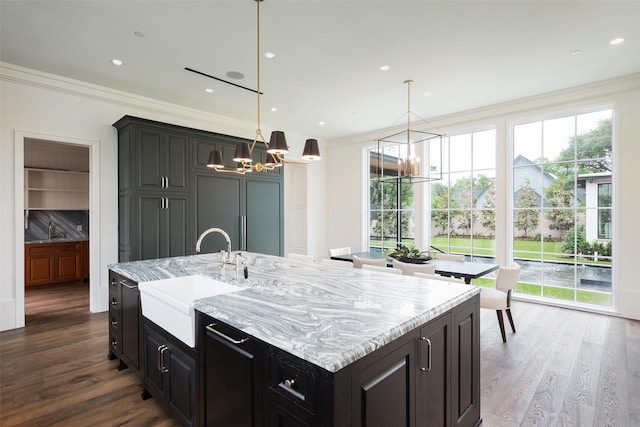 5531 Walnut Hill Ln, Dallas, TX 75229 - kitchen with a chandelier, a sink, crown molding, dark wood-style flooring, and light stone countertops