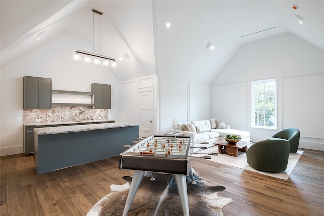 5531 Walnut Hill Ln, Dallas, TX 75229 - recreation room with vaulted ceiling and dark wood-style floors