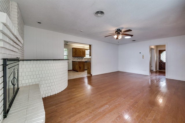 2972 Maydelle Ln, Farmers Branch, TX 75234 - unfurnished living room featuring a ceiling fan, healthy amount of natural light, and light wood finished floors