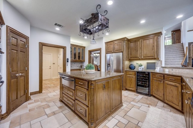 87 Eagle Chase Ln, Pottsboro, TX 75076 - kitchen featuring beverage cooler, stainless steel refrigerator with ice dispenser, a warming drawer, light stone counters, and a kitchen island