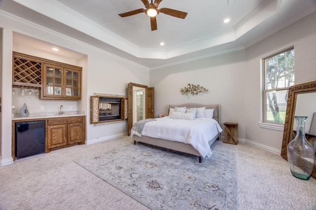 87 Eagle Chase Ln, Pottsboro, TX 75076 - bedroom with bar with sink, light carpet, refrigerator, crown molding, and a tray ceiling