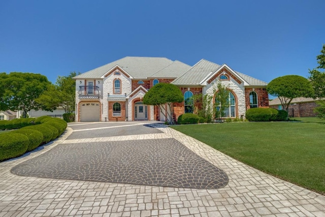 87 Eagle Chase Ln, Pottsboro, TX 75076 - view of front facade with curved driveway, an attached garage, a balcony, a front yard, and brick siding