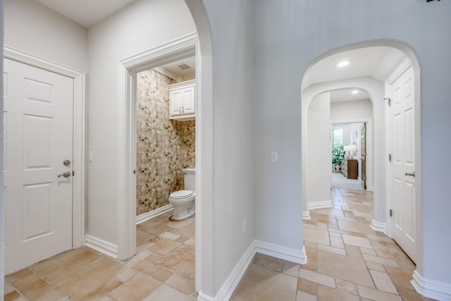87 Eagle Chase Ln, Pottsboro, TX 75076 - hall featuring stone tile flooring, arched walkways, and baseboards