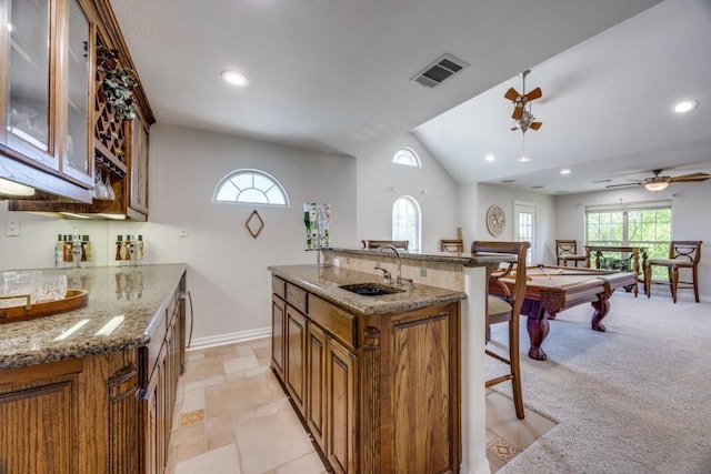 87 Eagle Chase Ln, Pottsboro, TX 75076 - kitchen featuring brown cabinetry, baseboards, billiards table, a sink, and vaulted ceiling