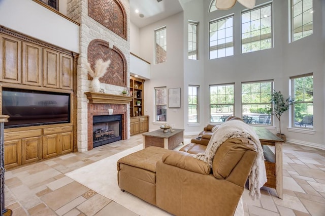 87 Eagle Chase Ln, Pottsboro, TX 75076 - living room featuring a fireplace, a high ceiling, baseboards, plenty of natural light, and recessed lighting