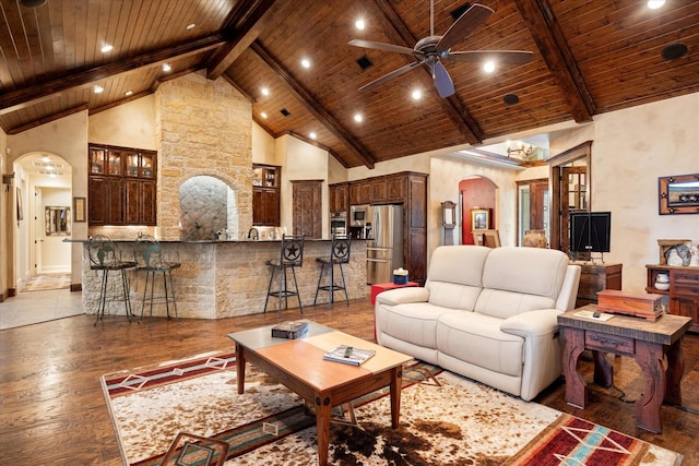 3712 Lonesome Creek Rd, Granbury, TX 76049 - living room with arched walkways, wood ceiling with exposed beams, a ceiling fan, high vaulted ceiling, and light wood-style flooring