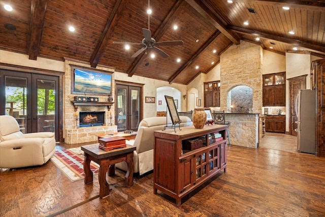 3712 Lonesome Creek Rd, Granbury, TX 76049 - living room with dark wood-type flooring, wood ceiling with exposed beams, a stone fireplace, high vaulted ceiling, and a ceiling fan