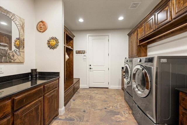 3712 Lonesome Creek Rd, Granbury, TX 76049 - laundry room featuring independent washer and dryer, cabinet space, recessed lighting, and light stone finish floors