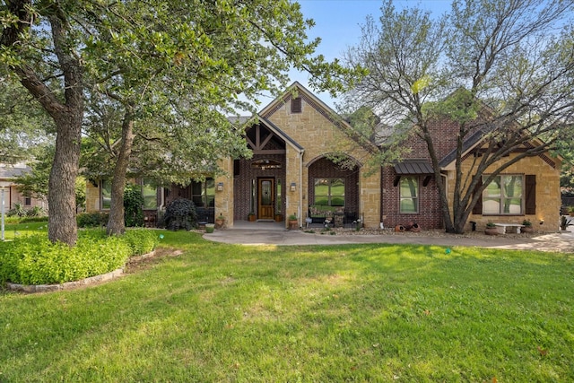 3712 Lonesome Creek Rd, Granbury, TX 76049 - view of front facade with a front yard, stone siding, and brick siding