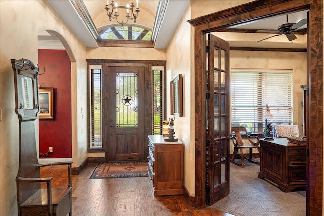 3712 Lonesome Creek Rd, Granbury, TX 76049 - entrance foyer featuring lofted ceiling, dark wood-style floors, baseboards, a chandelier, and arched walkways