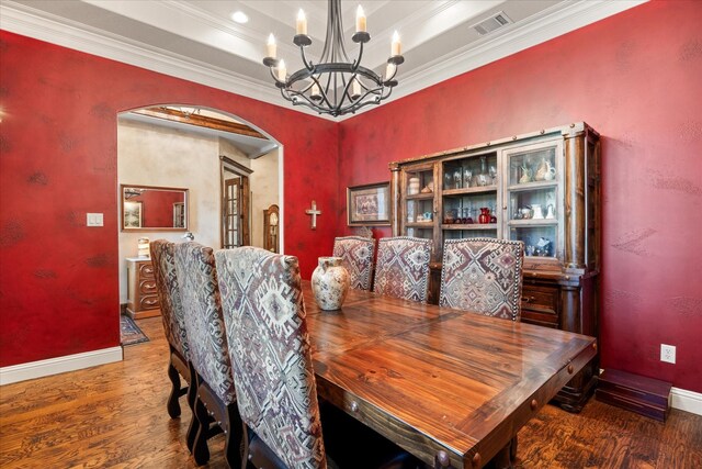 3712 Lonesome Creek Rd, Granbury, TX 76049 - dining area with arched walkways, wood finished floors, a chandelier, baseboards, and ornamental molding