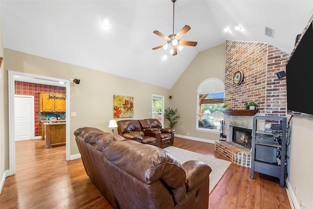 1621 Grandberry Dr, Melissa, TX 75454 - living room with ceiling fan, a fireplace, wood finished floors, high vaulted ceiling, and baseboards