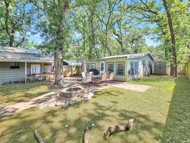 6505 Oakwood Lake Ct, Granbury, TX 76049 - rear view of property with an outdoor fire pit, a patio area, and metal roof