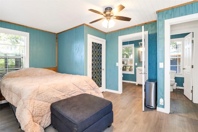 6505 Oakwood Lake Ct, Granbury, TX 76049 - bedroom with crown molding, wood finished floors, baseboards, wooden walls, and ceiling fan