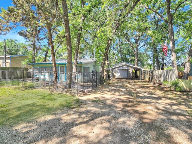 6505 Oakwood Lake Ct, Granbury, TX 76049 - rear view of house with driveway, a detached garage, and a carport
