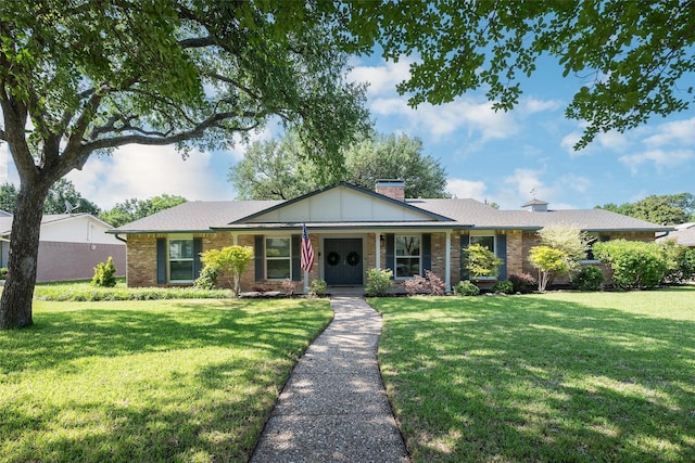4018 Crown Shore Dr, Dallas, TX 75244 - single story home with a front yard, a chimney, brick siding, and covered porch
