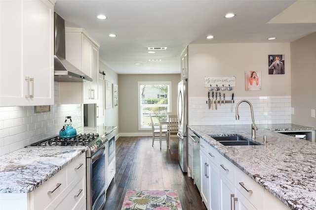4018 Crown Shore Dr, Dallas, TX 75244 - kitchen featuring stainless steel appliances, a sink, wall chimney exhaust hood, dark wood-style flooring, and light stone countertops