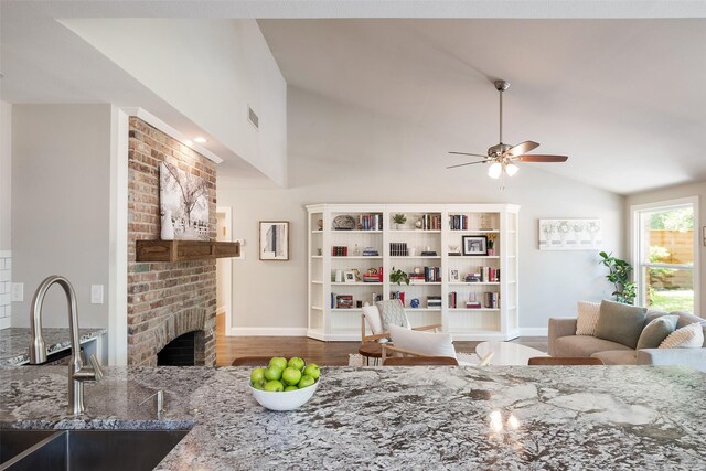 4018 Crown Shore Dr, Dallas, TX 75244 - living area featuring ceiling fan, wood finished floors, a brick fireplace, baseboards, and high vaulted ceiling