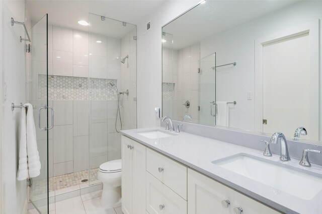 4018 Crown Shore Dr, Dallas, TX 75244 - bathroom featuring a stall shower, toilet, tile patterned flooring, double vanity, and recessed lighting
