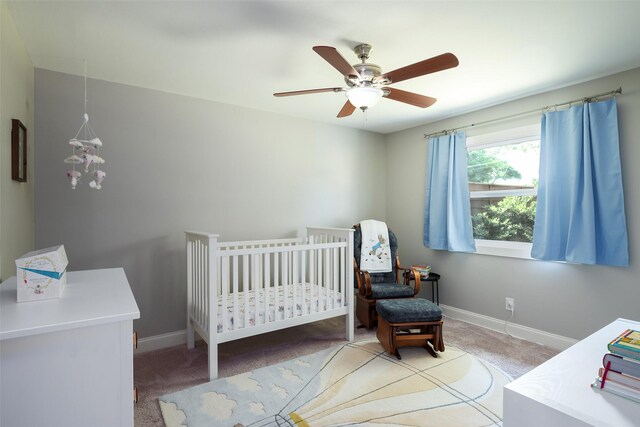 4018 Crown Shore Dr, Dallas, TX 75244 - carpeted bedroom with a crib, baseboards, and a ceiling fan