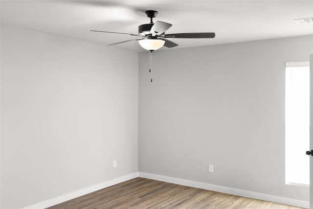 2404 Miller St, Denison, TX 75020 - empty room featuring baseboards, wood finished floors, and ceiling fan