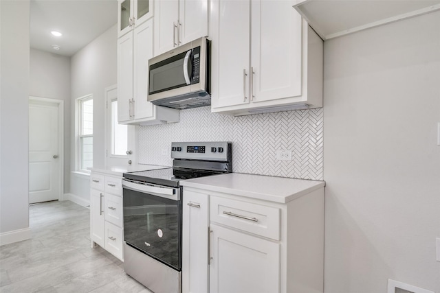 500 Melody Cir, Kaufman, TX 75142 - kitchen with appliances with stainless steel finishes, backsplash, light countertops, and white cabinets
