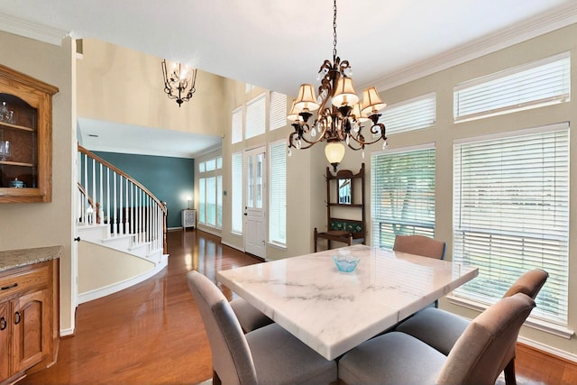 6916 Arvida Dr, Plano, TX 75023 - dining room with a chandelier, dark wood-style flooring, ornamental molding, stairway, and baseboards