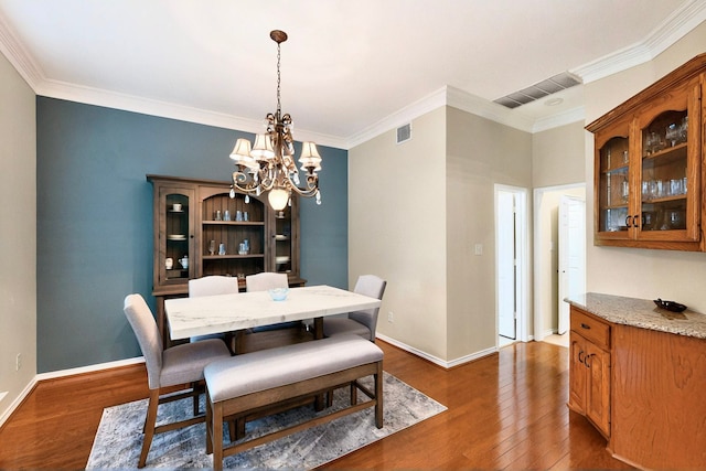 6916 Arvida Dr, Plano, TX 75023 - dining room featuring a chandelier, dark wood-style flooring, crown molding, and baseboards