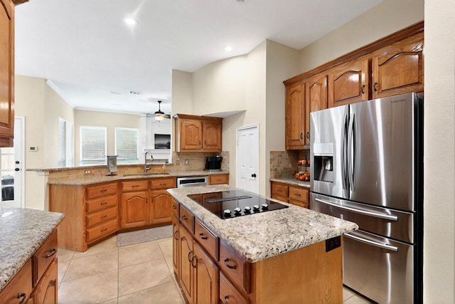 6916 Arvida Dr, Plano, TX 75023 - kitchen featuring stainless steel fridge, a sink, black electric cooktop, tasteful backsplash, and recessed lighting