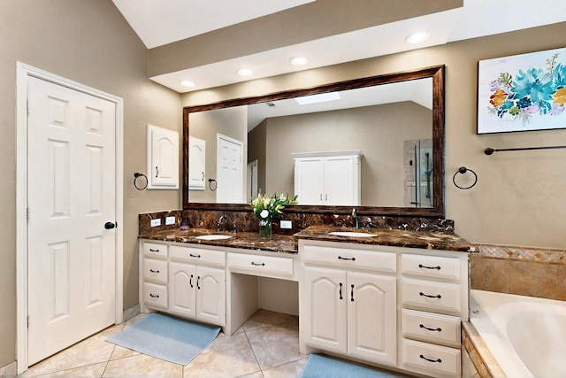 6916 Arvida Dr, Plano, TX 75023 - bathroom featuring tile patterned flooring, lofted ceiling, double vanity, tiled bath, and recessed lighting