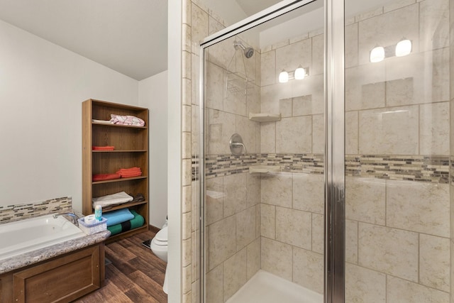 123 Little River Bnd, Mabank, TX 75156 - full bathroom with wood finished floors, a shower stall, toilet, and a garden tub