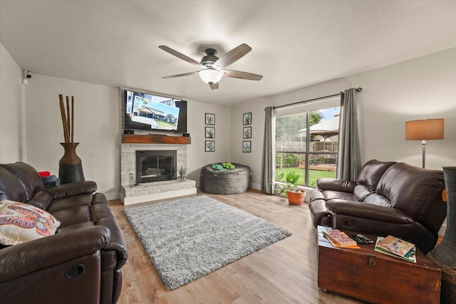 2302 Warwick Ave, Grand Prairie, TX 75052 - living room with ceiling fan, a fireplace, wood finished floors, and baseboards
