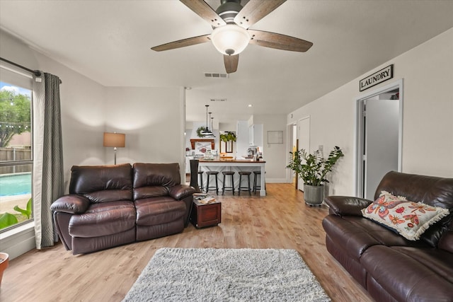 2302 Warwick Ave, Grand Prairie, TX 75052 - living area featuring a ceiling fan and light wood finished floors