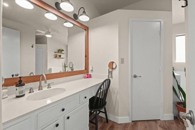 2302 Warwick Ave, Grand Prairie, TX 75052 - bathroom featuring wood finished floors, ceiling fan, vanity, and baseboards