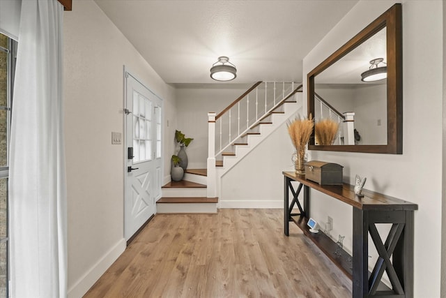 2302 Warwick Ave, Grand Prairie, TX 75052 - entrance foyer featuring stairs, wood finished floors, and baseboards