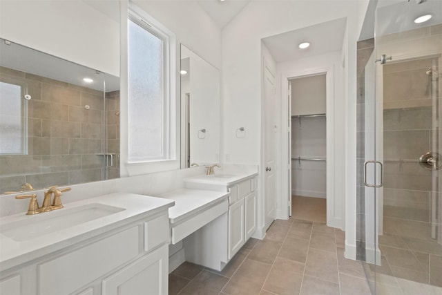 1812 Welker Dr, Van Alstyne, TX 75495 - bathroom featuring a stall shower, two vanities, tile patterned floors, a walk in closet, and recessed lighting