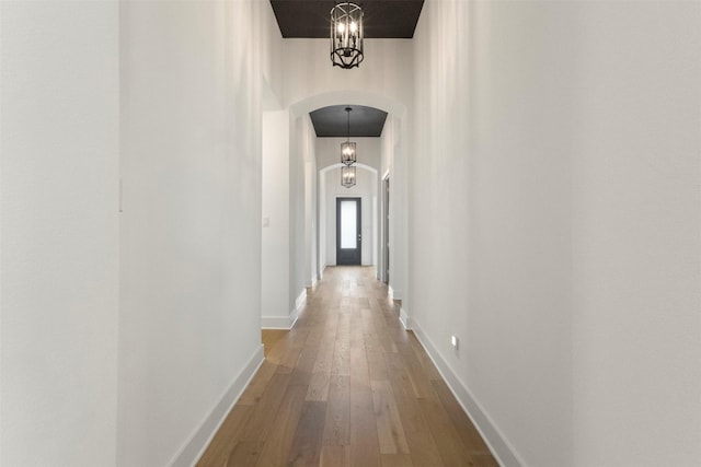 1812 Welker Dr, Van Alstyne, TX 75495 - hall featuring arched walkways, hardwood / wood-style floors, and baseboards