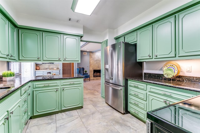 907 Glen Dell Dr, Irving, TX 75061 - kitchen featuring stainless steel fridge with ice dispenser, dark stone counters, electric range, and backsplash