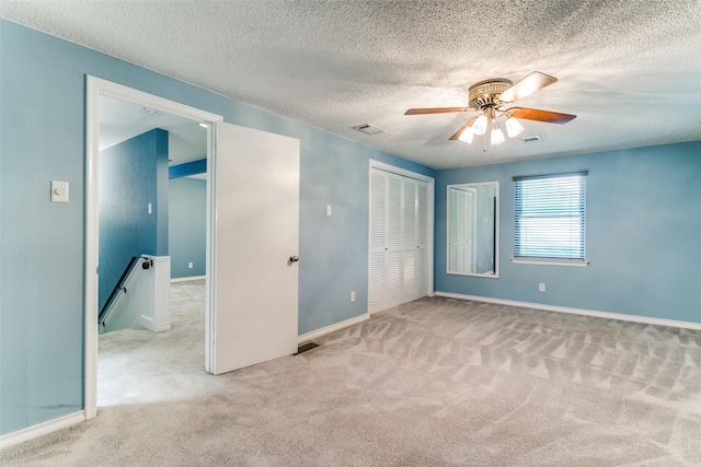 907 Glen Dell Dr, Irving, TX 75061 - unfurnished bedroom with carpet, a textured ceiling, a closet, and a ceiling fan