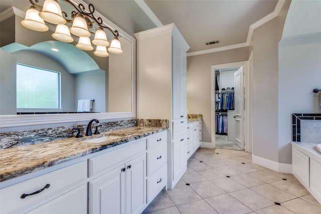 11626 Capitan Ln, Frisco, TX 75033 - full bath with vanity, a garden tub, baseboards, a spacious closet, and ornamental molding
